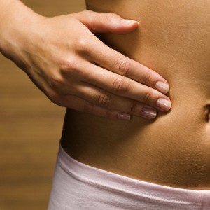 Woman Touching Her Stomach