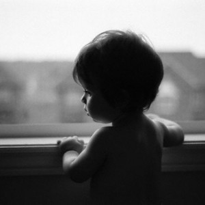 Young Boy Looking Out Window