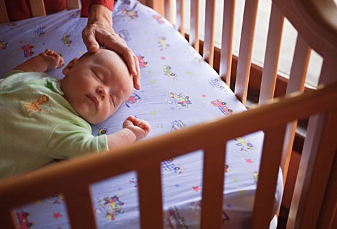 getty_rm_photo_of_mother_putting_baby_down_to_sleep
