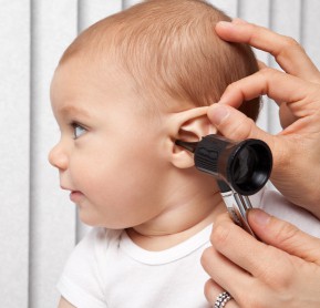 An 8 month old baby getting his ear checked.